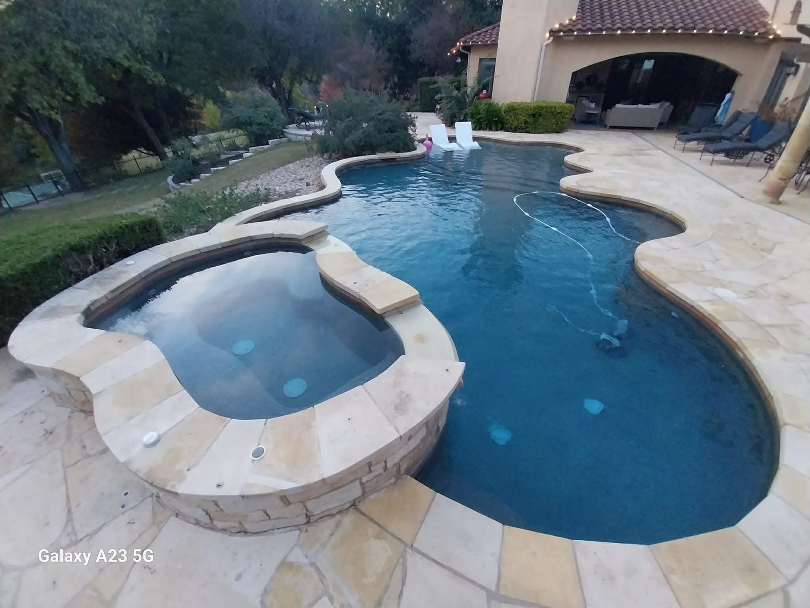 Crystal-clear backyard pool maintained weekly by The Pool Police — Austin TX Hill Country