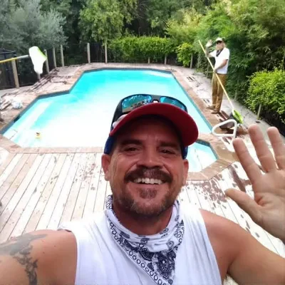 Keith Mallette, owner and lead pool technician of The Pool Police, on the job at a backyard pool in Austin TX